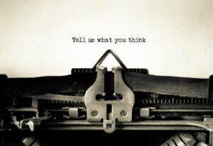 Vintage typewriter with "tell us what you think" typed onto the paper