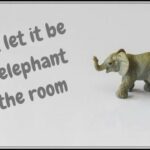 A model elephant with the words "Don't let it be the elephant in the room"