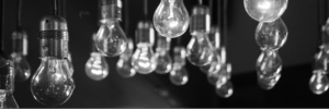 lightbulbs in background overlaid by 'Mentoring Skills in the Workplace' text