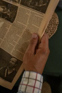 close up view of a hand holding a newspaper