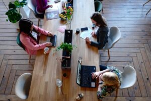 Wellbeing and Resilience in the Workplace - a group of women working together around a shared desk